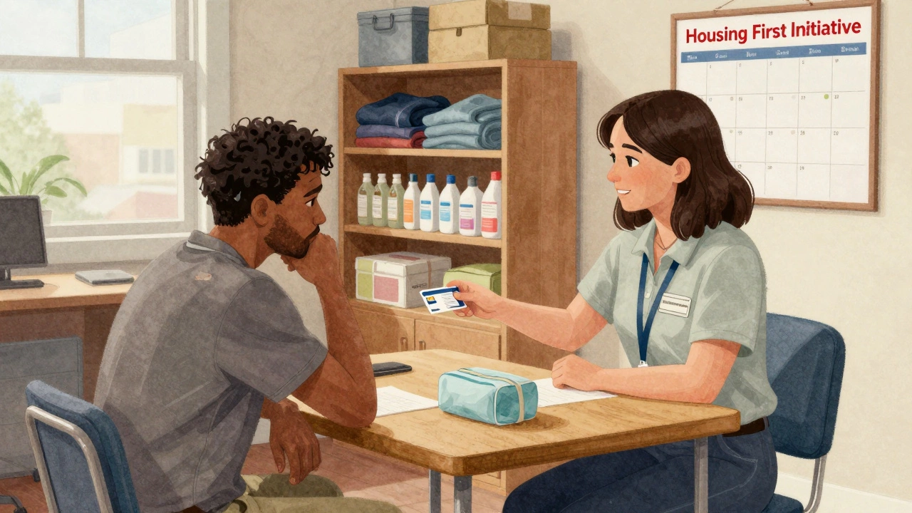 Case manager giving a hygiene kit and SIM card to a guest inside the shelter, shelves of donations behind.